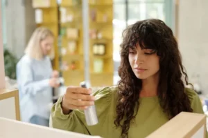 a woman looking into a cosmetic product